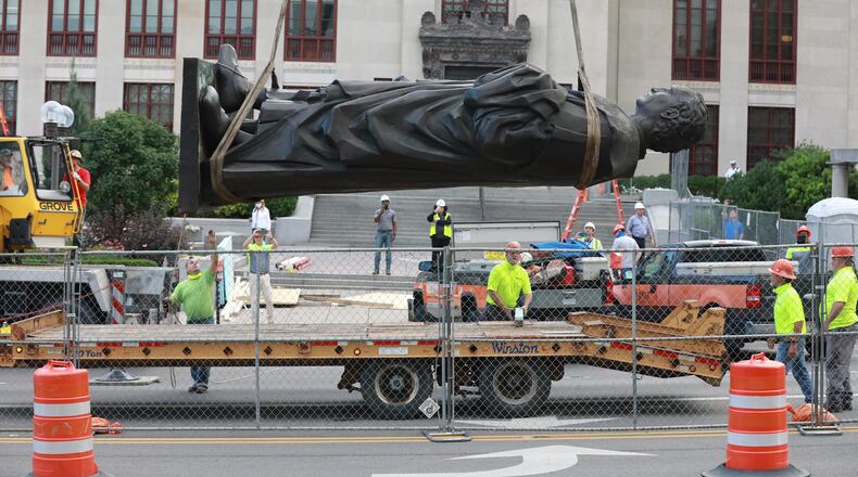 Workers remove the Christhopher Columbus statue on the Broad Street side of Columbus City Hall Wednesday, July 1, 2020.  The city says it will be replaced with a different statue or artwork that reflects diversity. A city news releaase said it will be placed in safekeeping at a secure city facility. The Christopher Columbus statue was a gift from the people of Genoa, Italy, in 1955.  (Doral Chenoweth/Columbus Dispatch)