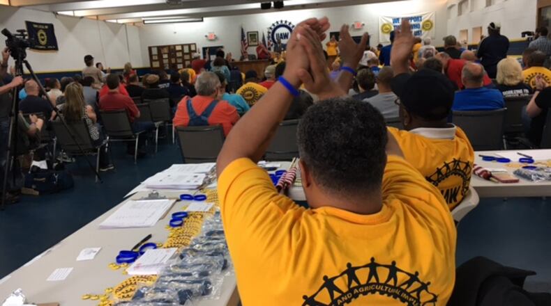 United Auto Workers organizers and workers respond to a speaker at a meeting Sunday at UAW Local 696’s hall in Dayton. The UAW is trying to gather enough election authorization signatures to force a representation election at Fuyao Glass America in Moraine. THOMAS GNAU/STAFF