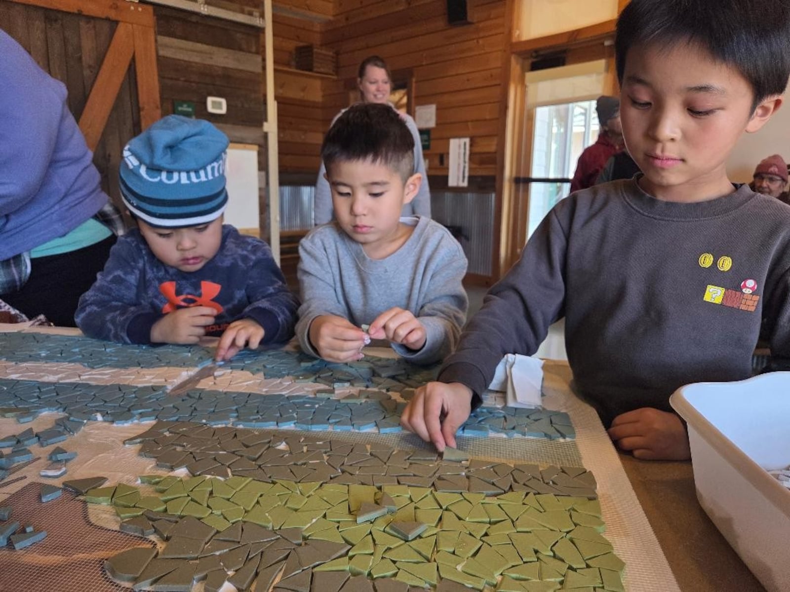 Children learn the art of mosaic from the Mosaic Institute. Photo courtesy of Jes McMillan