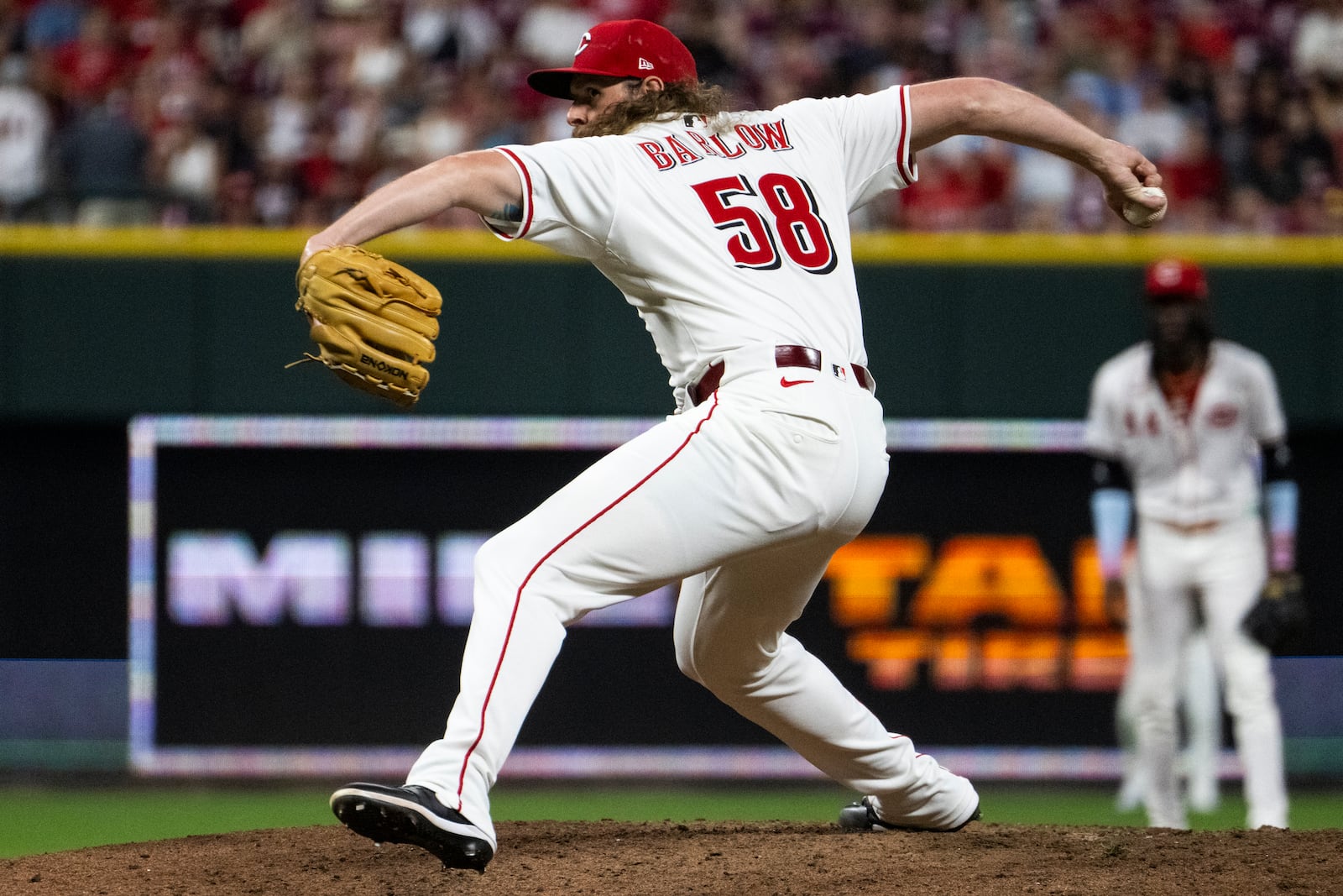 Cincinnati Reds pitcher Scott Barlow delivers a pitch in the 10th inning of a baseball game against the Milwaukee Brewers, Saturday, Aug. 16, 2025, in Cincinnati. (AP Photo/Michael Swensen)