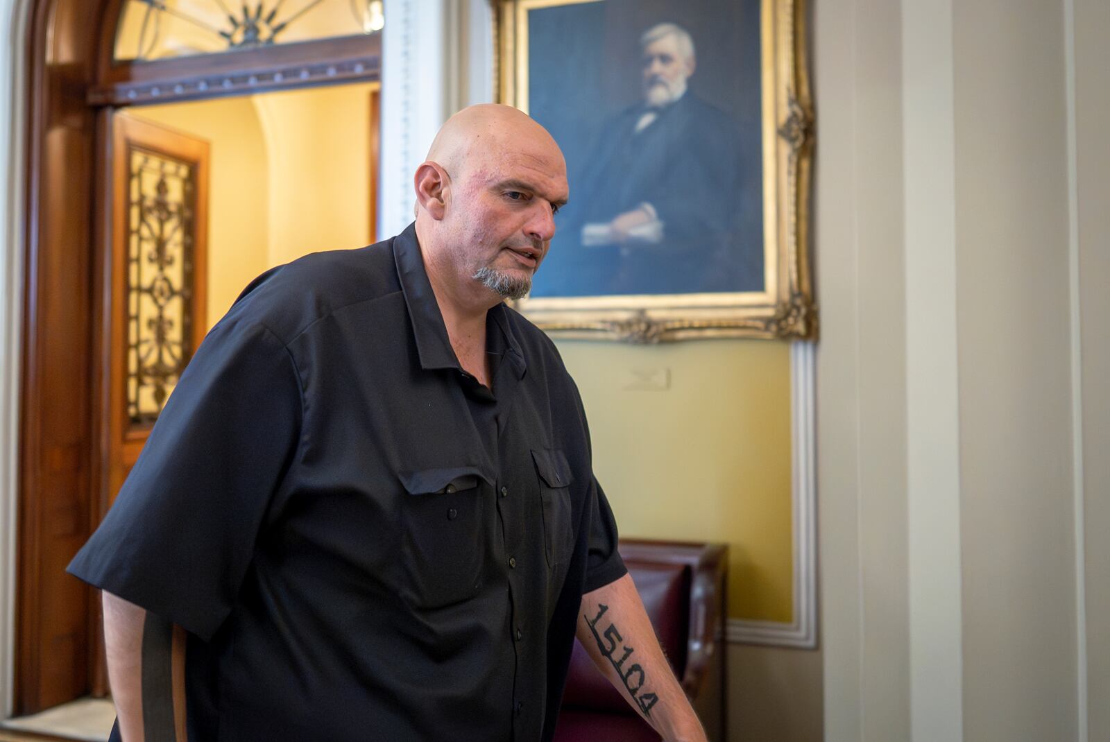 FILE - Sen. John Fetterman, D-Pa., leaves the chamber as the Senate holds a procedural vote on the nomination of Emil Bove to be a U.S. Circuit Court judge for the 3rd U.S. Circuit Court of Appeals, at the Capitol in Washington, July 24, 2025. (AP Photo/J. Scott Applewhite, File)