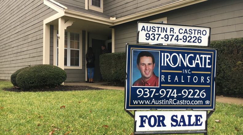 Engaged couple Ryan Runyeon and Malloree Hagerty, both millennials, are looking to buy a home. Realtor Austin Castro shows the pair some options in Centerville. STAFF PHOTO / HOLLY SHIVELY