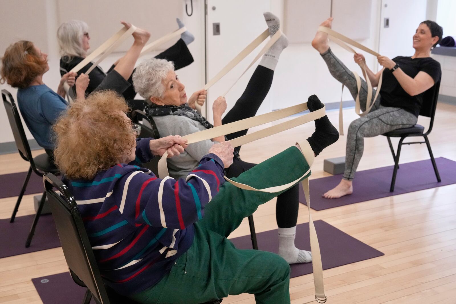 Whitney Chapman, right, conducts a chair yoga class at the Marlene Meyerson JCC Manhattan, in New York, March 28, 2025. (AP Photo/Richard Drew)