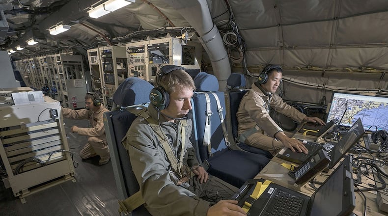 MIT Lincoln Laboratory personnel Joseph Zurkus (left) and Jacob Huang (right) operate a protected tactical waveform (PTW) modem and collect data while Ted O’Connell, also from Lincoln Lab, monitors terminal equipment to ensure everything is working properly during flight testing Oct. 5, 2017. A team from Hanscom Air Force Base, MIT Lincoln Laboratory and the MITRE Corp. are working to ensure that the PTW, a government-owned waveform that provides resilient, anti-jam communications, will work in flight. (Courtesy photo/MIT Lincoln Laboratory)