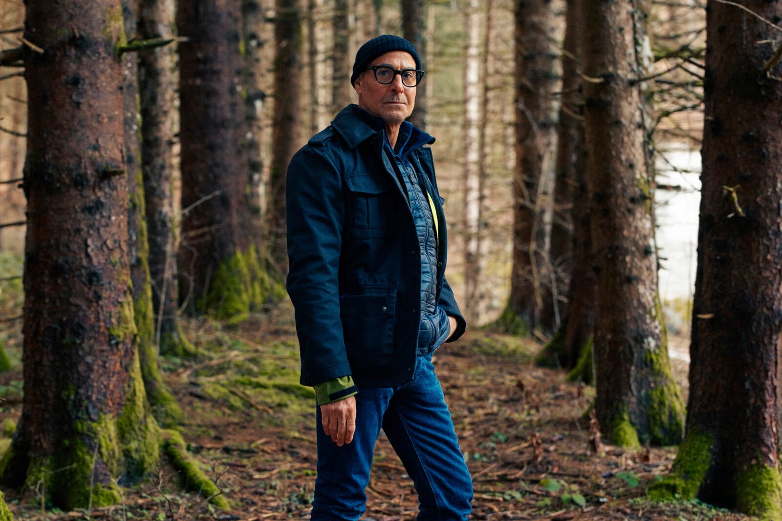 This image released by National Geographic shows Stanley Tucci posing in the woods in the Trentino-Alto Adige in northern Italy, during the filming of his series "Tucci in Italy." (National Geographic via AP)
