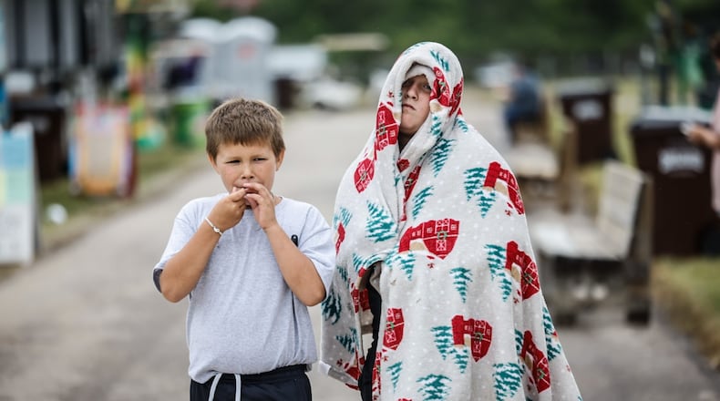 Hudson Cook, left and Brantley Mahan walk around the Montgomery County Fair Wednesday morning July 10, 2024. Hurricane Beryl brought in cool temperatures and a brisk wind. JIM NOELKER/STAFF