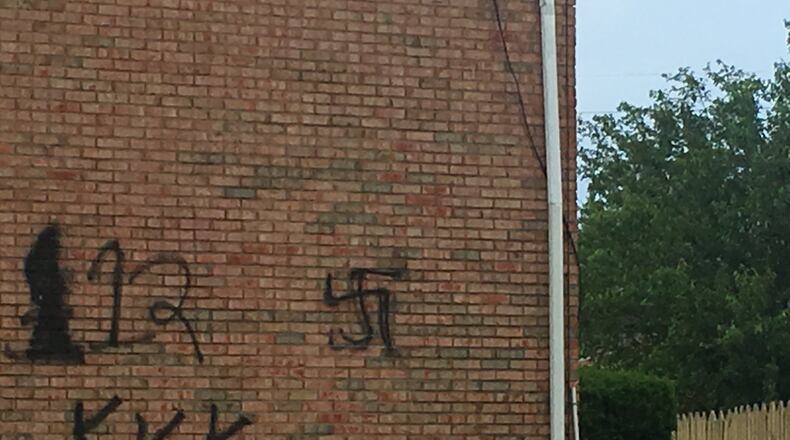 Someone this week spray painted KKK and swastika signs on the side of a condo in Trenton. RICK MCCRABB/STAFF