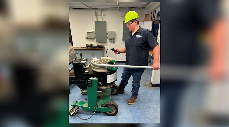 Owen Rhoades, a 17-year-old Miami Valley Career Technology Center student, at work as an electrician's apprentice. CONTRIBUTED