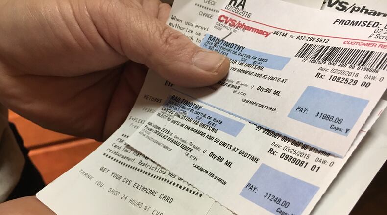 Tim Rau holds up reciepts for his insulin, which increased in price nearly 60 percent in just one year. KATIE WEDELL/STAFF