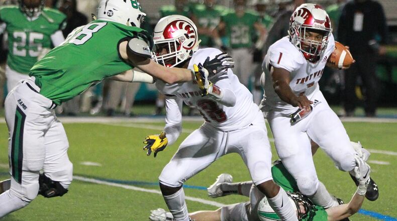 Trotwood QB Keon’tae Huguely (with ball) is taken down from behind as Michael Schweinefuss of Badin (left) closes. Trotwood-Madison defeated Badin 20-7 in a D-III, Region 12 high school football final at Miamisburg on Friday, Nov. 22, 2019. MARC PENDLETON / STAFF
