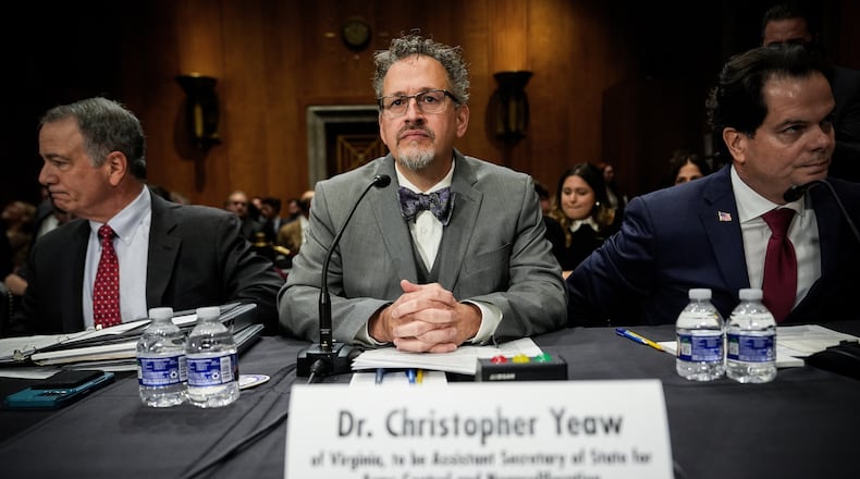 FILE - Christopher Yeaw, center, arrives to a Senate Foreign Relations Committee confirmation hearing on his nomination to be an assistant Secretary of State, Nov. 19, 2025, on Capitol Hill in Washington. (AP Photo/Julia Demaree Nikhinson, File)