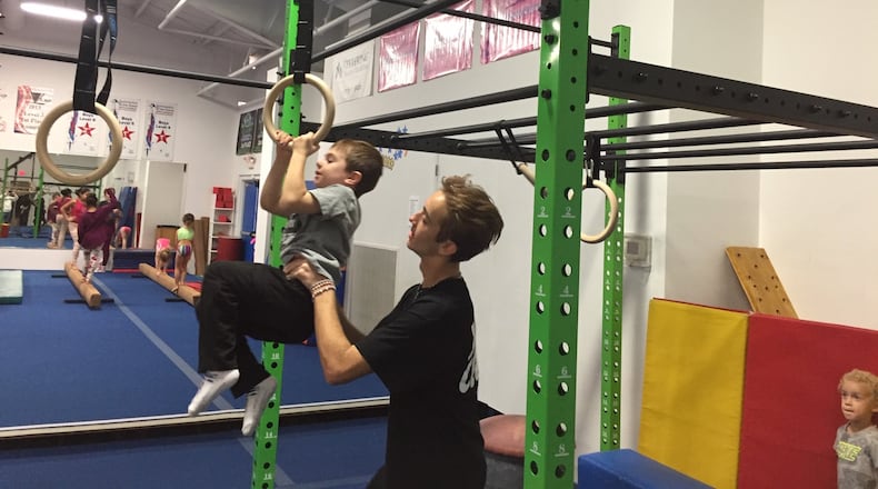 Cooper Hatton doing the ring tuck with Coach Austin Defoor at Kids are Tops. CONTRIBUTED