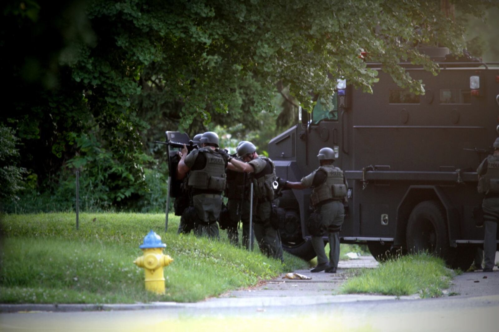Members of the Dayton SWAT team advances on the front door of a home on West Hillcrest Avenue on Wednesday, June 28, 2017. (Jim Noelker/Staff)
