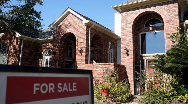 A real estate sign is shown at a home for sale, Wednesday, Jan. 13, 2021, in Houston. (Melissa Phillip/Houston Chronicle via AP)