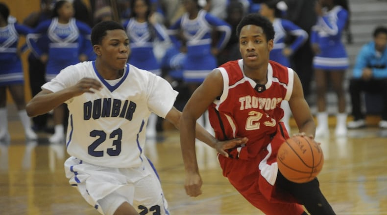Trotwood’s Jamar Johnson (with ball) is pressed by Dunbar’s Kareem Moore-Clansy. Dunbar hosted Trotwood-Madison in a boys high school basketball game on Tuesday, Jan. 12, 2016. MARC PENDLETON / STAFF