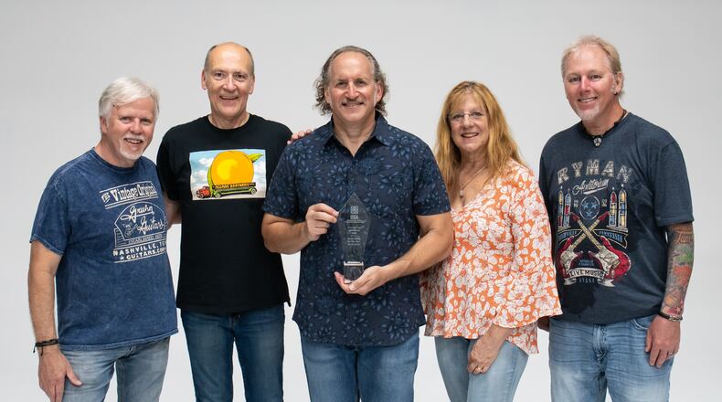 Ludlow Creek, (left to right) Allen Seals, Jeff Friend, Tom Scarpelli, Michelle Scarpelli and Dave Benson, celebrates the release of “Finding Our Way Back” at Tipp Roller Mill in Tipp City on Saturday, Oct. 8.