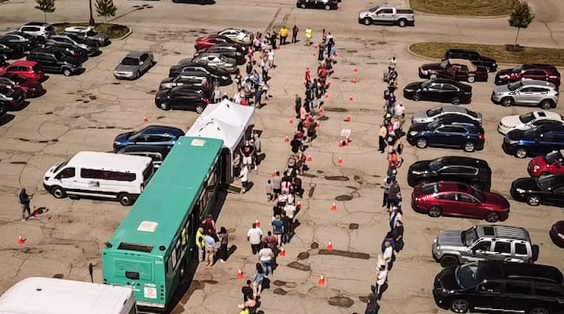 Hundreds waited in line at the Dayton Metro Library in Huber Heights for a COVID-19 vaccine on Tuesday. Sept. 14, 2021. Jim Noelker/Staff