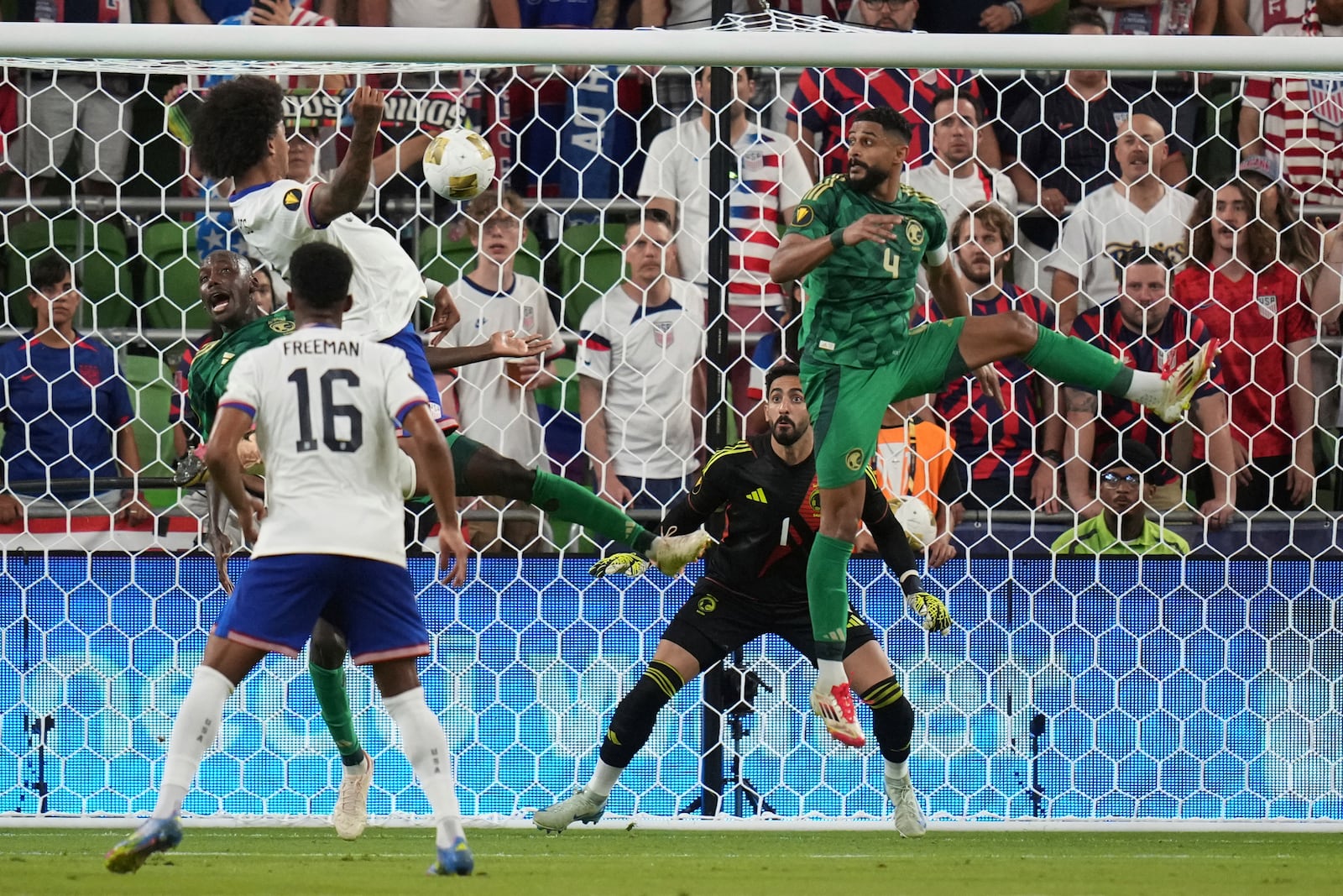 Saudi Arabia's Nawaf Alaqidi (1) and Abdulelah Alamri (4) look to block a shot by United States' Chris Richards, left, during a CONCACAF Gold Cup soccer match, Thursday, June 19, 2025, in Austin, Texas. (AP Photo/Eric Gay)