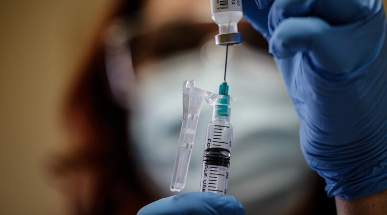 Jacinda Snider, a collaborative pharmacist distributes COVID-19 booster shots at Grafton Oaks Nursing Home on Grafton Ave. Tuesday Jan. 11, 2022. Snider volunteers long hours including evenings and weekends to give people vaccines. She has provided hundreds of Ohioans against COVID-19. JIM NOELKER/STAFF