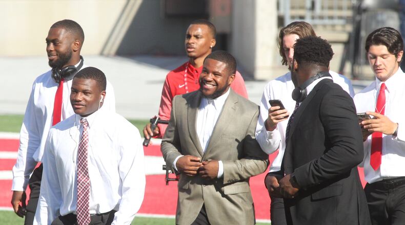 Ohio State’s Mike Weber, center, smiles as the team arrives at Ohio Stadium before a game against UNLV on Saturday, Sept. 23, 2017, in Columbus. David Jablonski/Staff