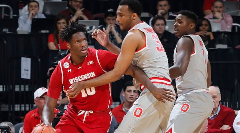 Wisconsin's Nigel Hayes (10) drives against Ohio State's Trevor Thompson (32) and Jae'Sean Tate (1) during the first half at Value City Arena in Columbus, Ohio, on Thursday, Feb. 23, 2017. (Adam Cairns/Columbus Dispatch/TNS)