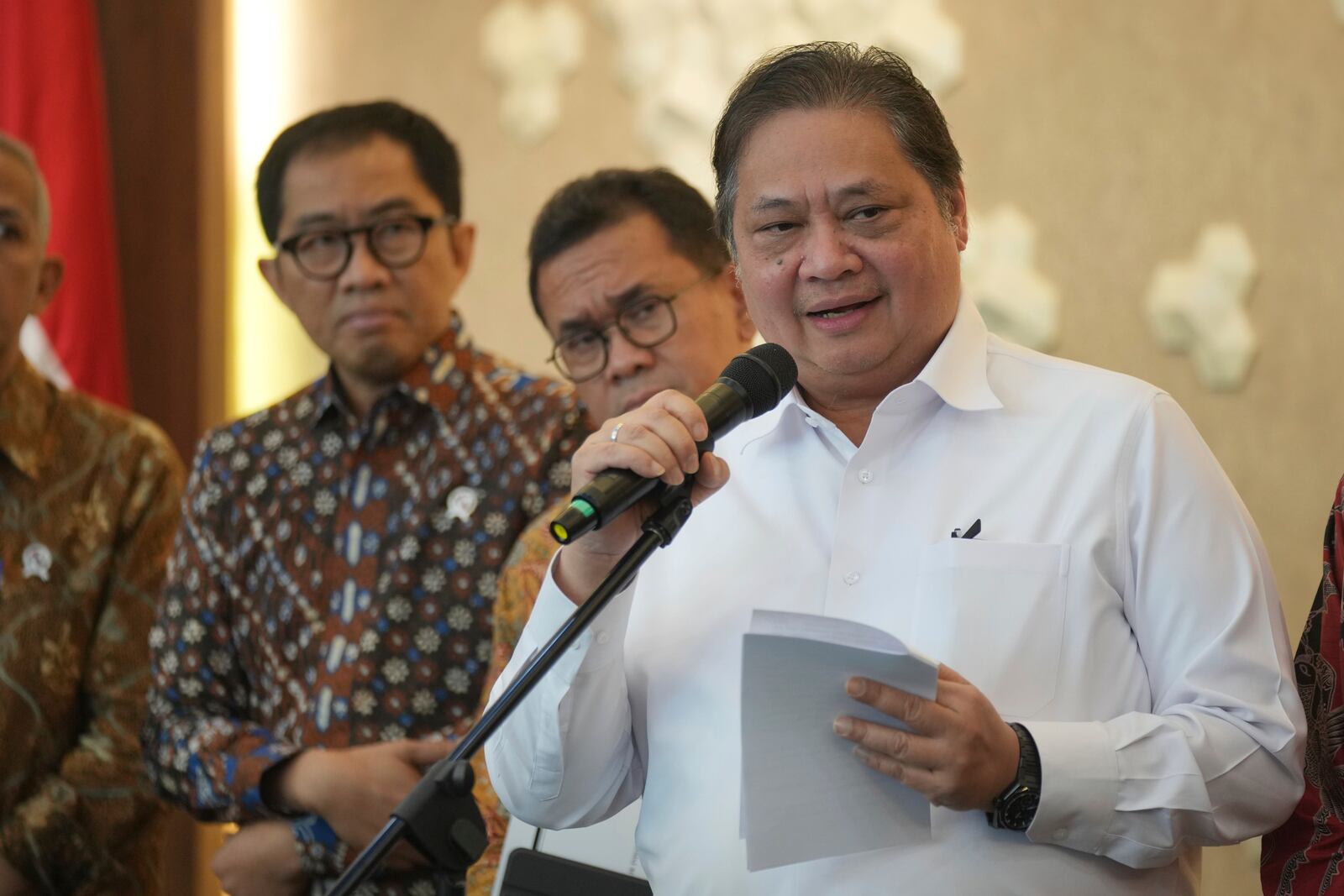 Indonesian Coordinating Minister for Economics Airlangga Hartarto, right, speaks during a press conference in Jakarta, Indonesia, Monday, April 7, 2025. (AP Photo/Tatan Syuflana)