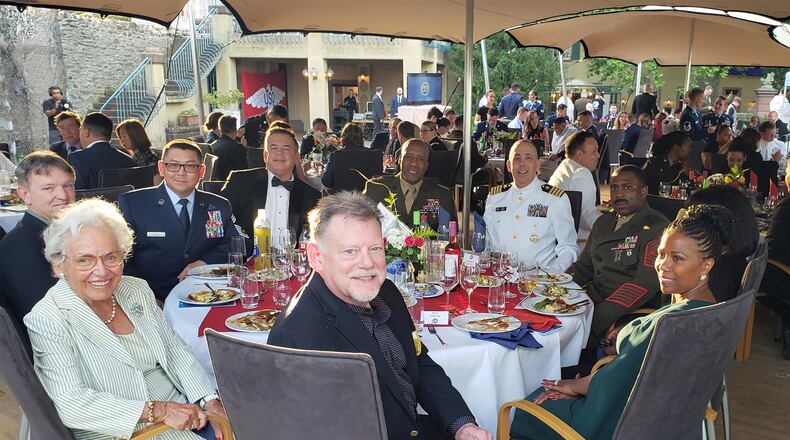 Gary McGill (bottom front center) seated at the table at the Armed Forces Network awards ceremony in July with from left counterclockwise Mary String, Master Sgt. Jimmy Mention, Capt. Brook DeWalt, Gen. Michael Langley (keynote speaker), Hal Pittman, Chief Master Sgt. Jason David, Max Lerner and Helga Haub. CONTRIBUTED