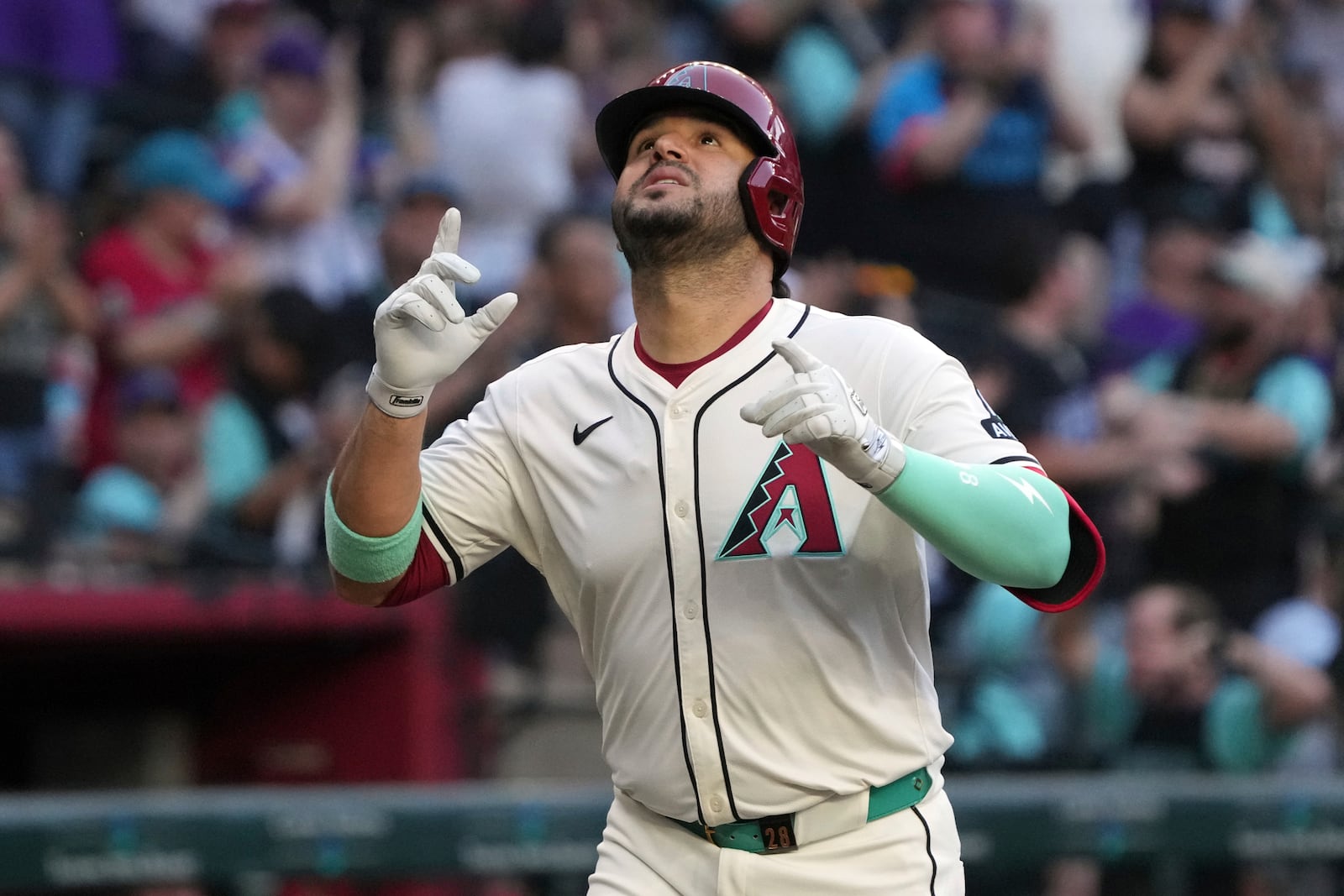 Arizona Diamondbacks' Eugenio Suárez celebrates after hitting a solo home run against the Atlanta Braves in the first inning during a baseball game, Saturday, April 26, 2025, in Phoenix. (AP Photo/Rick Scuteri)