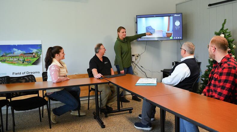 Jennifer Knisley of Isaiah's Place in Troy discusses the progress on creating Miami County's Child Advocacy Center with other Isaiah's Place staff in the new space created for the center. CONTRIBUTED PHOTO