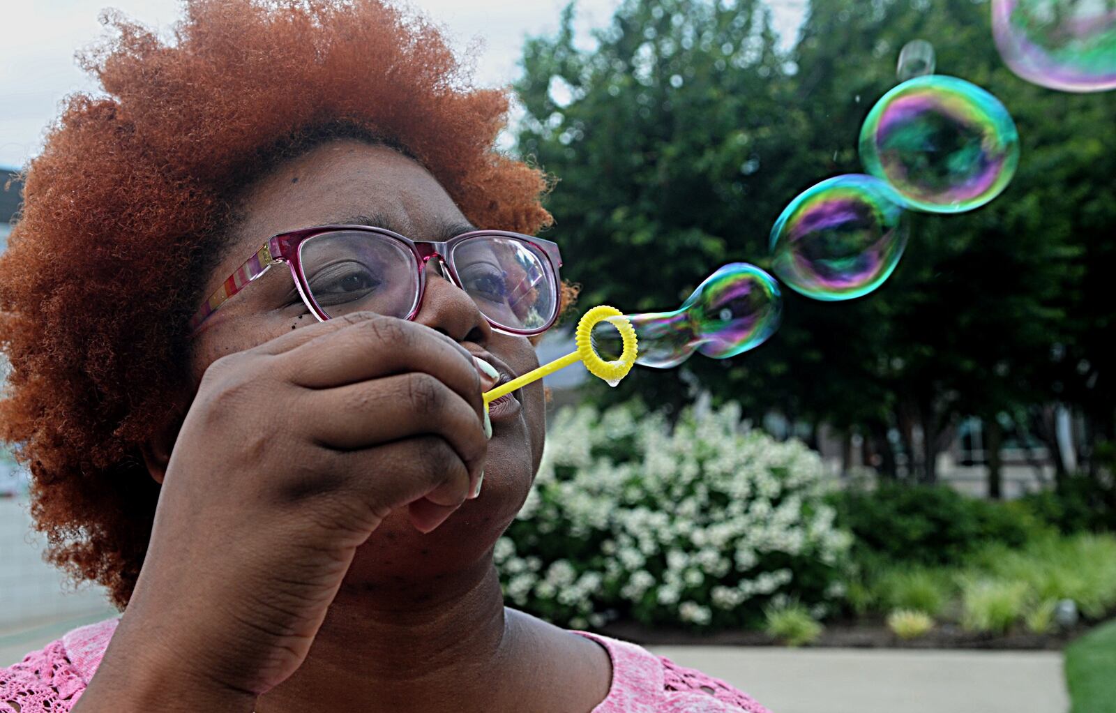 EyVaughn Standifer participates in a CareSource Bubble Break at RiverScape MetroPark on Tuesday, June 20, 2017, one of many people who took advantage of the June weather near the river last week. MARSHALL GORBY / STAFF
