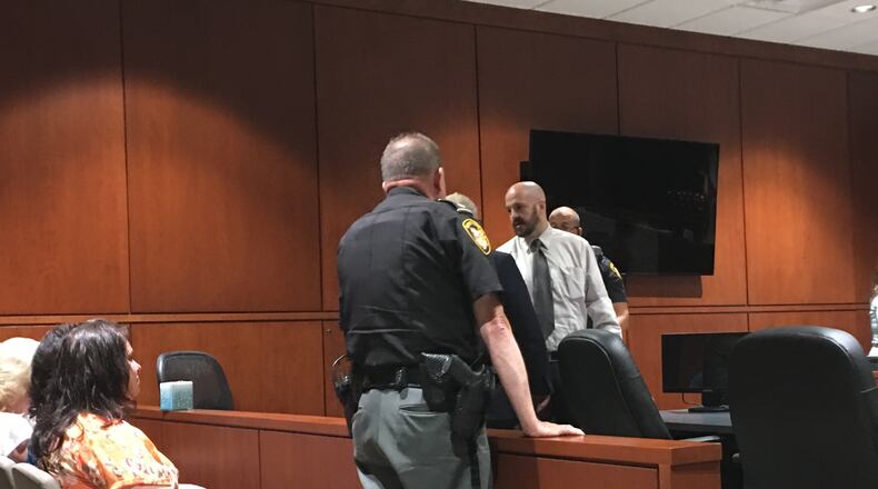 Deputies get Freddie Green ready to go back to jail after a mistrial was declared Thursday in Warren County Common Pleas Court.Family and friends filled a section of the courtroom gallery in his support.