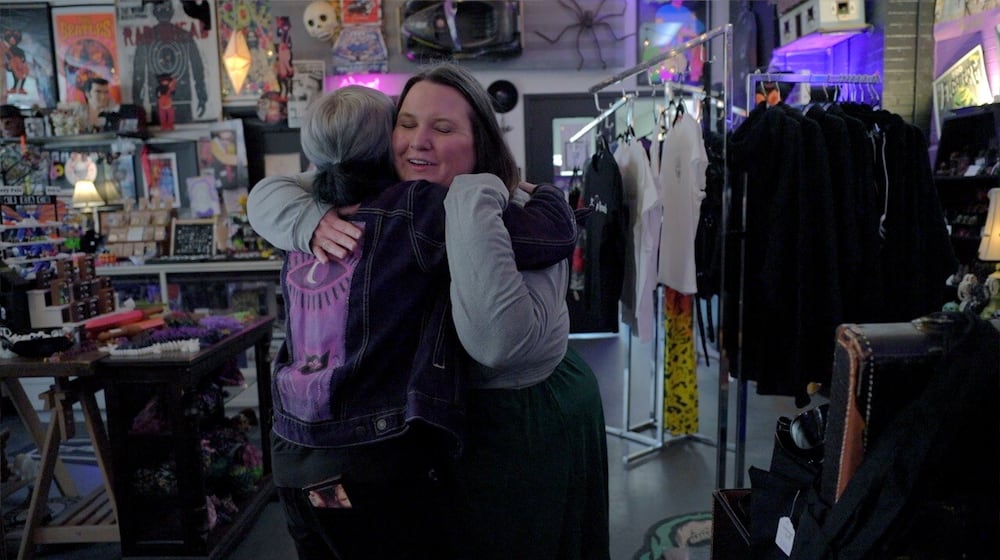 Amanda Hollingsworth hugs the owner of Strange Records in the Morrow Arts Center. Hollingsworth says the record shop has become a safe space for LGTBQ+ members of this small Warren County community.
Photo by: Keith BieryGolick
