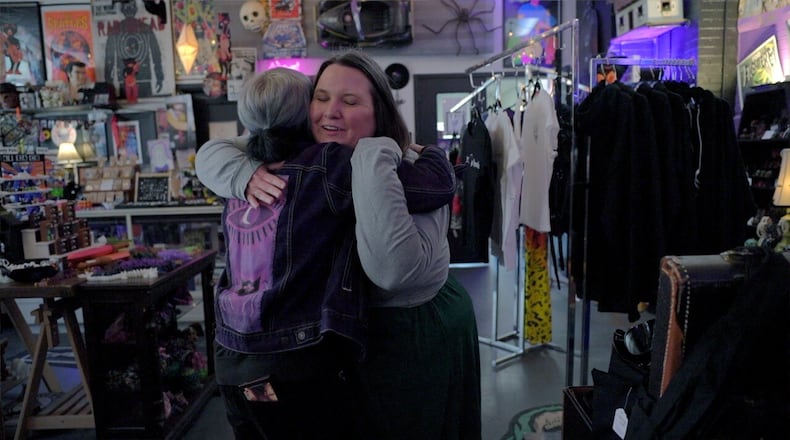 Amanda Hollingsworth hugs the owner of Strange Records in the Morrow Arts Center. Hollingsworth says the record shop has become a safe space for LGTBQ+ members of this small Warren County community.
Photo by: Keith BieryGolick