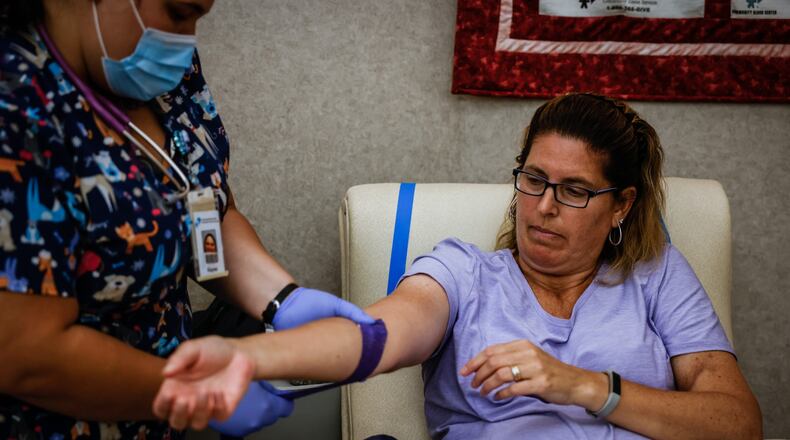Nancy Gillespie, from Dayton, donates blood Monday, June 28, 2021, at the Community Blood Center near downtown Dayton. JIM NOELKER/STAFF