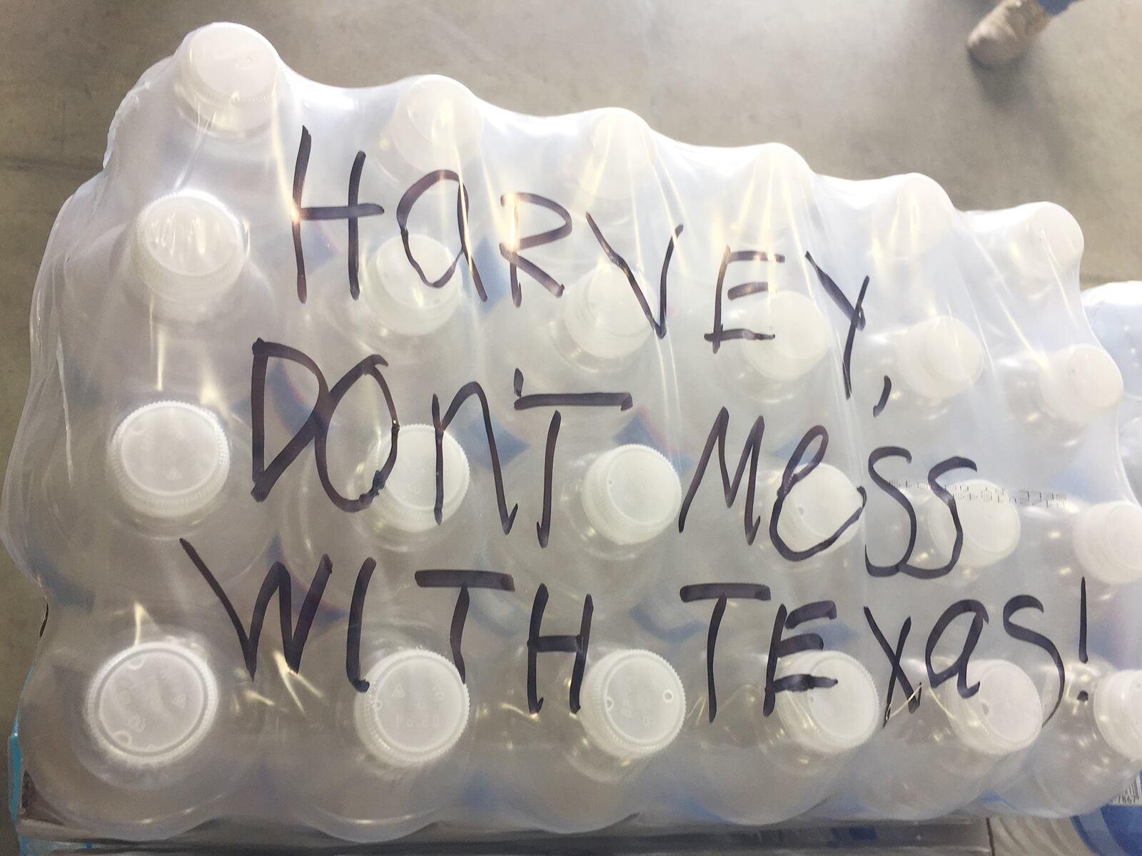 Messages have been left at The Foodbank in Dayton on donated cases of water and pallets bound to victims of Harvey in Texas. SUBMITTED