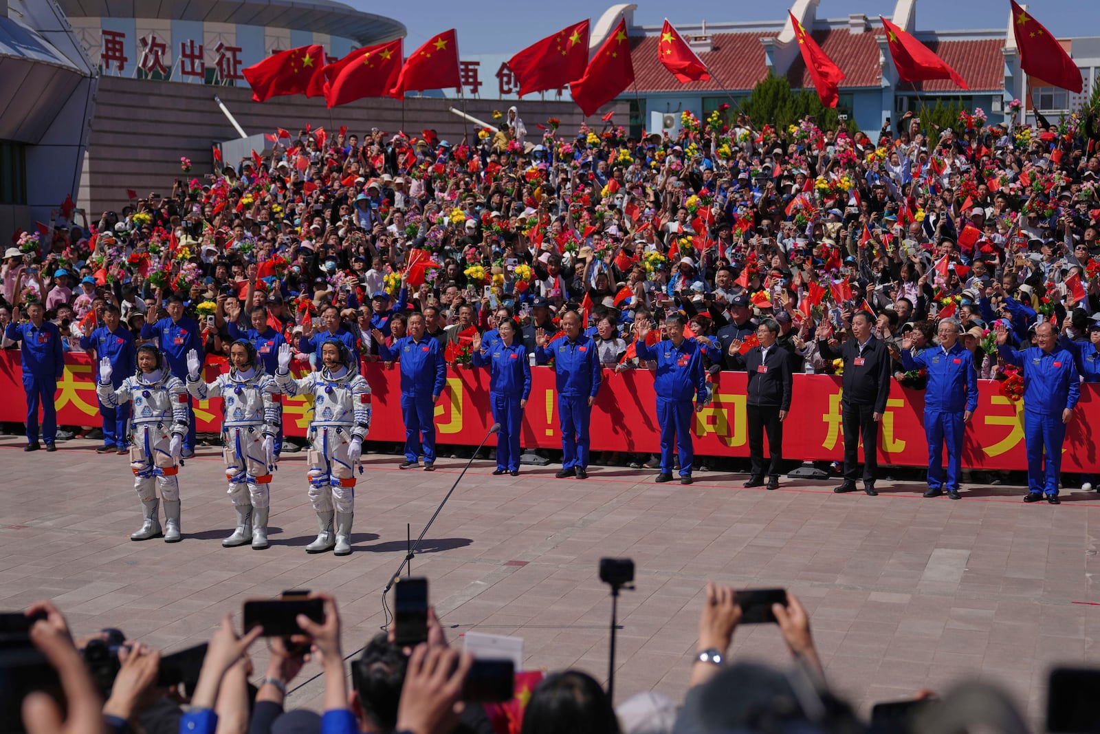 Chinese astronauts for the Shenzhou 20 mission, from right, Chen Zhongrui, Chen Dong and Wang Jie wave as they attend a send-off ceremony for their manned space mission at the Jiuquan Satellite Launch Center in northwestern China, Thursday, April 24, 2025. (AP Photo/Andy Wong)