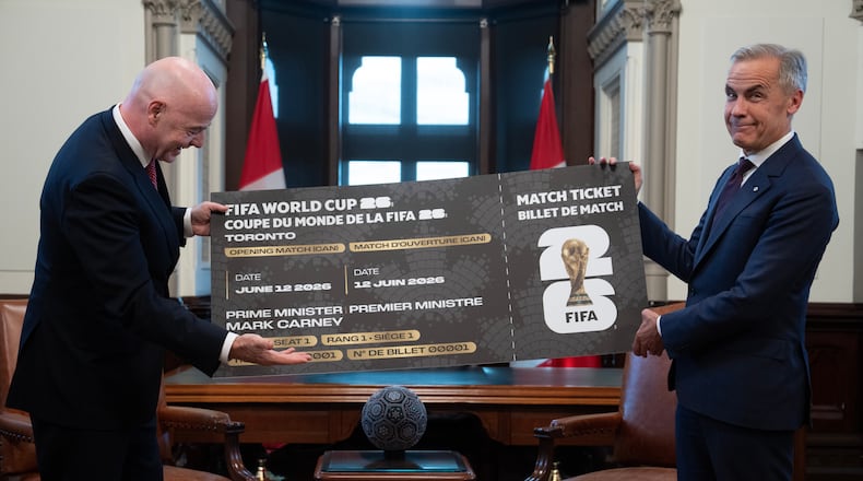 Canada Prime Minister Mark Carney, right, is presented with a novelty World Cup ticket by FIFA President Gianni Infantino on Parliament Hill in Ottawa, Ontario, Friday, Oct. 10, 2025. (Adrian Wyld/The Canadian Press via AP)
