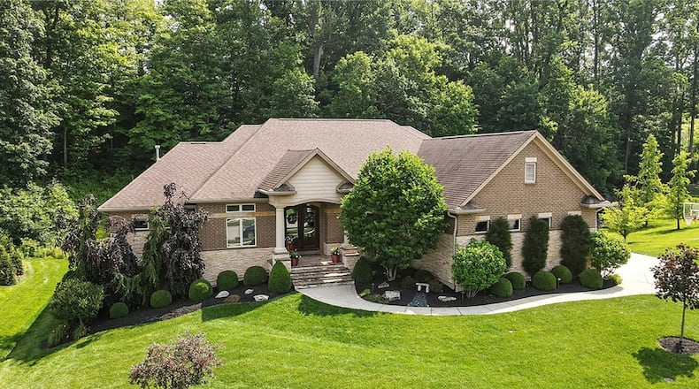 This custom ranch has four bedrooms on two levels, a walk out basement and inground pool.