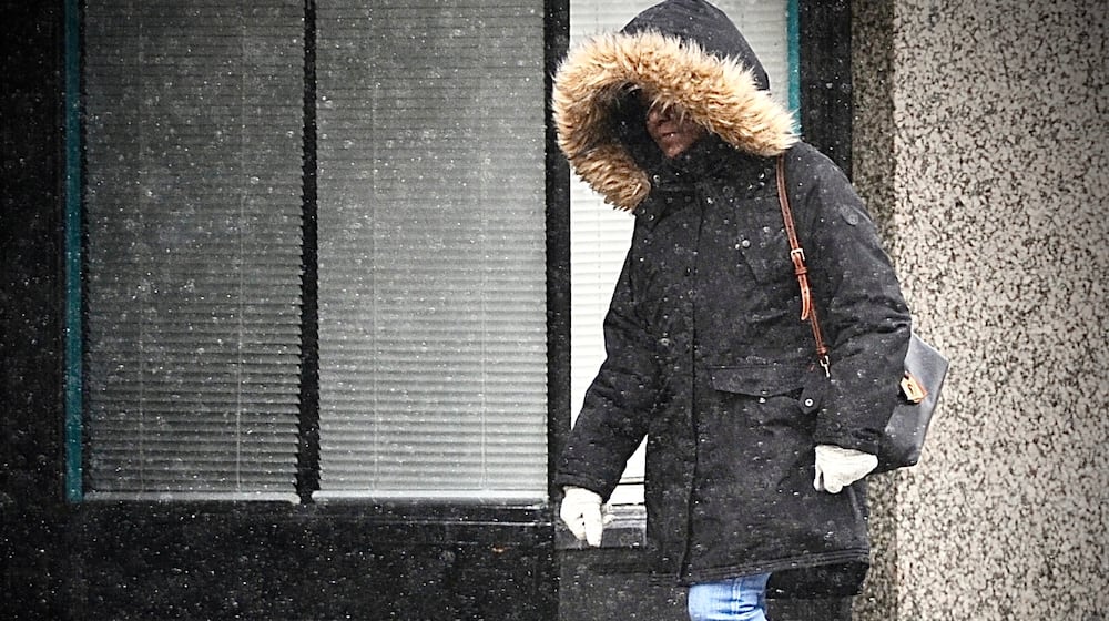 The region will be under a winter weather advisory for up to 2 inches of snow through Friday. This woman was dressed warmly Thursday, Jan. 18, 2024, during a light snowfall in downtown Dayton before the heavier snow showers. MARSHALL GORBY\STAFF