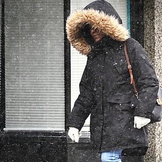 The region will be under a winter weather advisory for up to 2 inches of snow through Friday. This woman was dressed warmly Thursday, Jan. 18, 2024, during a light snowfall in downtown Dayton before the heavier snow showers. MARSHALL GORBY\STAFF
