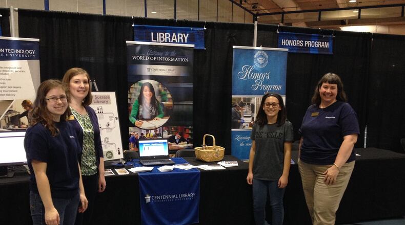 Cedarville University Academic Librarian Julie Deardorff (right) is the recipient of the 2016 Jay Ladd Distinguished Service Award. She is pictured with (from left) Laura Ullom (2016 Centennial Library Intern), Kirsten Setzkorn (2012 Centennial Library Intern) and help prospective student Lydia Jacobsen at the Centennial Library table in December. CONTRIBUTED