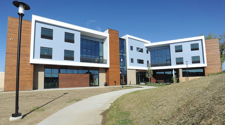 OneFifteen Living, an apartment complex that is part of the addiction treatment and recovery center OneFifteen, celebrated with a ribbon cutting on Friday. The new 26,300-square-foot building has 29 double-occupancy rooms with separate living spaces for men and women, group kitchens, a fitness center, meditation room, coffee bar and rooms for individual and group therapy. Outdoor space is still being developed. “OneFifteen Living will give people a safe place to live while they continue their journey of recovery,” said President and CEO Marti Taylor. MARSHALL GORBY\STAFF