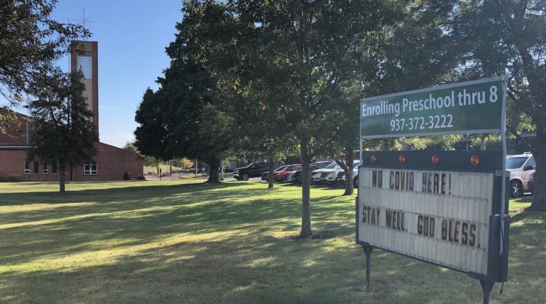 A sign outside St. Brigid's Catholic School in Xenia celebrates the school's lack of COVID-19 cases in the first month of in-person school on Friday, Sept. 25, 2020.