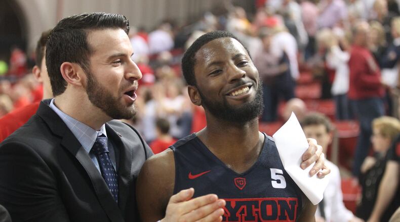 Dayton’s Brian Frank and Scoochie Smith leave the court after a victory against Davidson on Friday, Feb. 24, 2017, at Belk Arena in Davidson, N.C. David Jablonski/Staff