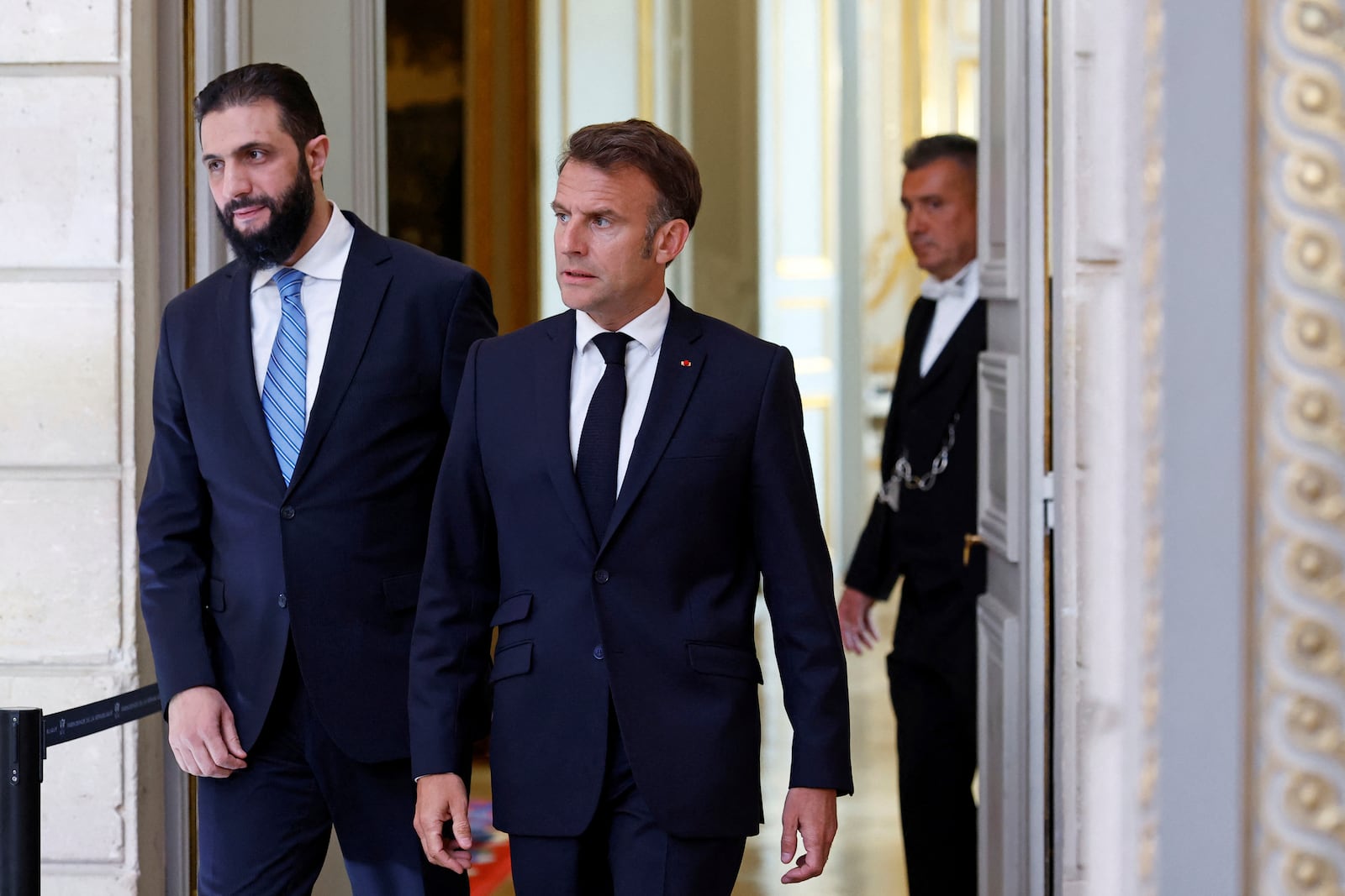Syria's interim President Ahmad al-Sharaa, left, and French President Emmanuel Macron arrive for a joint press conference at the Elysee Palace in Paris, Wednesday, May 7, 2025. (Stephanie Lecocq/Pool via AP)