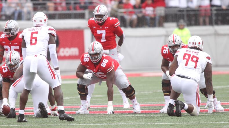 Ohio State’s Dwayne Haskins lines up behind Michael Jordan (73), Malcolm Pridgeon (66) and Thayer Munford (75), against Rutgers on Saturday, Sept. 8, 2018, at Ohio Stadium in Columbus. David Jablonski/Staff