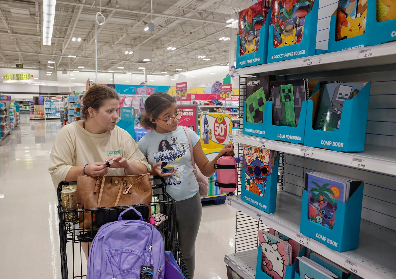 Kaylee Hall, left, and her daughter Evie Hall, of Springfield, look for school supplies at Meijer on Friday, July 25, 2025, in Springfield. JOSEPH COOKE/STAFF