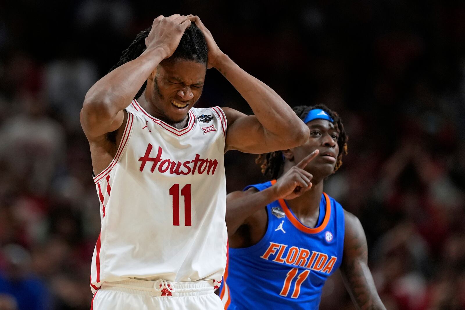 Houston forward Joseph Tugler reacts as Florida guard Denzel Aberdeen celebrates after scoring during the second half in the national championship at the Final Four of the NCAA college basketball tournament, Monday, April 7, 2025, in San Antonio. (AP Photo/Brynn Anderson)