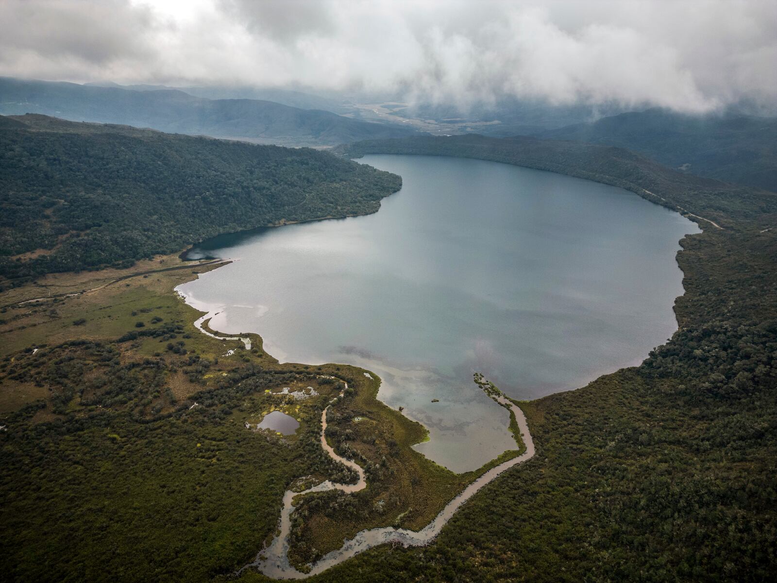 FILE - Clouds float over the Chingaza lagoon in the paramo of Chingaza National Natural Park, Colombia, Tuesday, March 19, 2024, the primary water source for millions of residents in the capital city of Bogota. (AP Photo/Ivan Valencia, File)