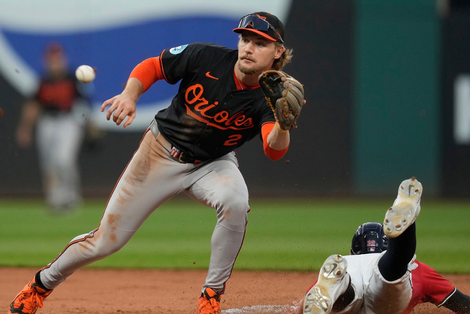 Baltimore Orioles shortstop Gunnar Henderson (2) takes the throw as Cleveland Guardians' Nolan Jones, right, steals second base in the sixth inning of a baseball game in Cleveland, Monday, July 21, 2025. (AP Photo/Sue Ogrocki)